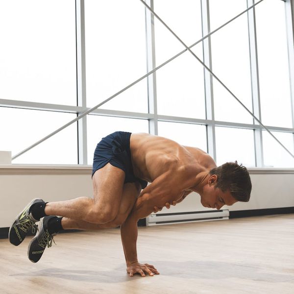 Man performing a controlled flexibility exercise in a modern studio.